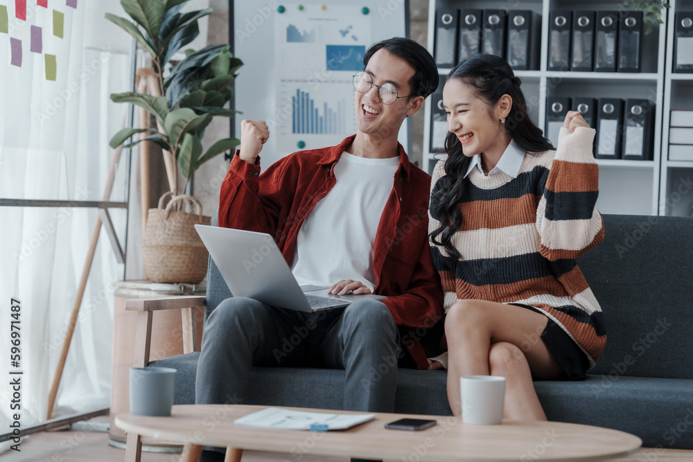 Obraz premium Good news by mail. Happy married asian chinese couple sit at home office by paperwork business accounting. Glad young spouses read financial report get profit tax refund check information using laptop