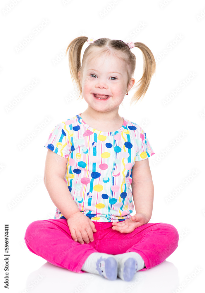 Happy little girl with Downs syndrom looks at camera. Isolated on white background Happy little girl with Downs syndrom looks at camera. Isolated on white background