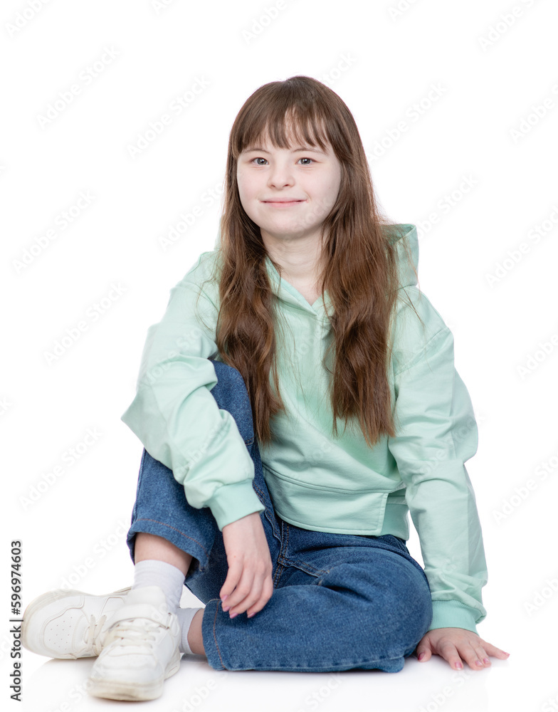 Smiling teen girl with Downs syndrom wearing casual clothes looks at camera. Isolated on white background Smiling teen girl with Downs syndrom wearing casual clothes looks at camera. Isolated on white background