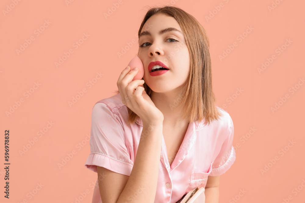 Young woman with cosmetic bag and makeup sponge on pink background, closeup Young woman with cosmetic bag and makeup sponge on pink background, closeup