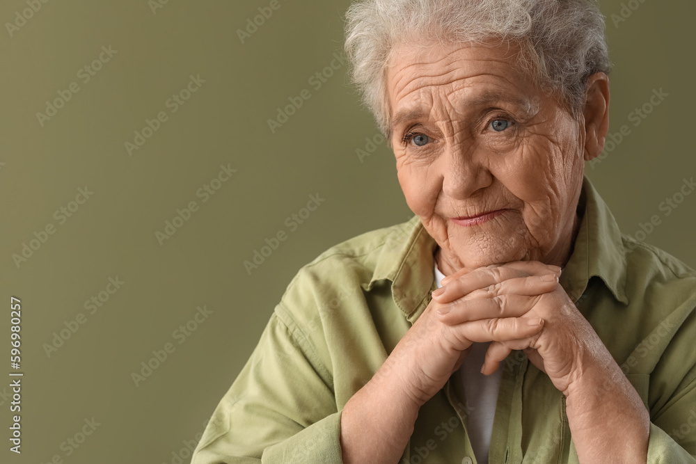 Thinking senior woman on green background, closeup Thinking senior woman on green background, closeup