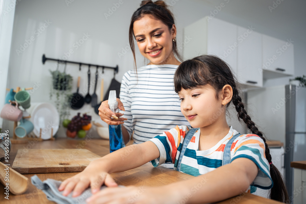 Caucasian beautiful mother cleaning house with young kid daughter. Caucasian beautiful mother cleaning house with young kid daughter.