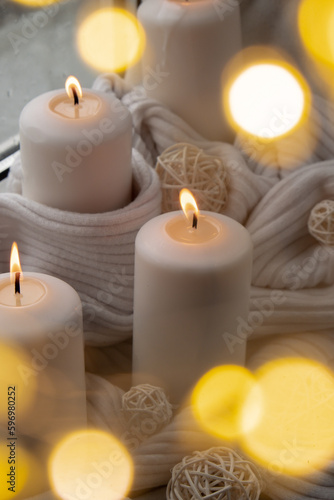 Bokeh light Home fragnance concept autumn holidays at cozy home on the windowsill Hygge aesthetic atmosphere on knitted white sweater. Still life of micro moment candid slow living. Mental health