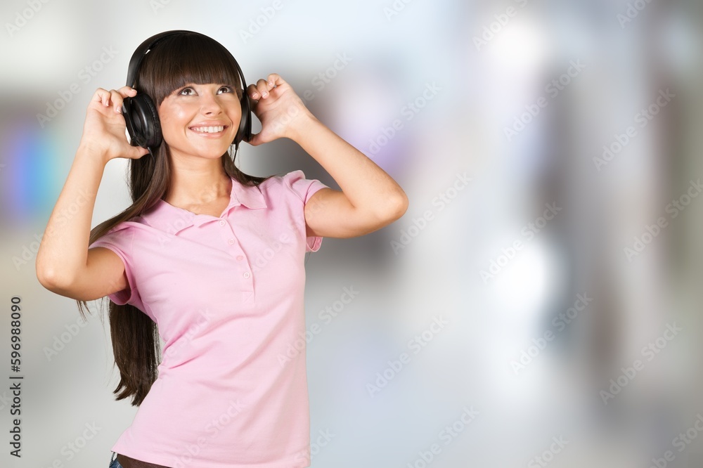 Young satisfied woman listen to music
