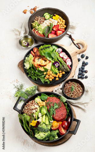 Healthy vegetarian and vegan salads and Buddha Bowls with vitamins, antioxidants, protein on light background.
