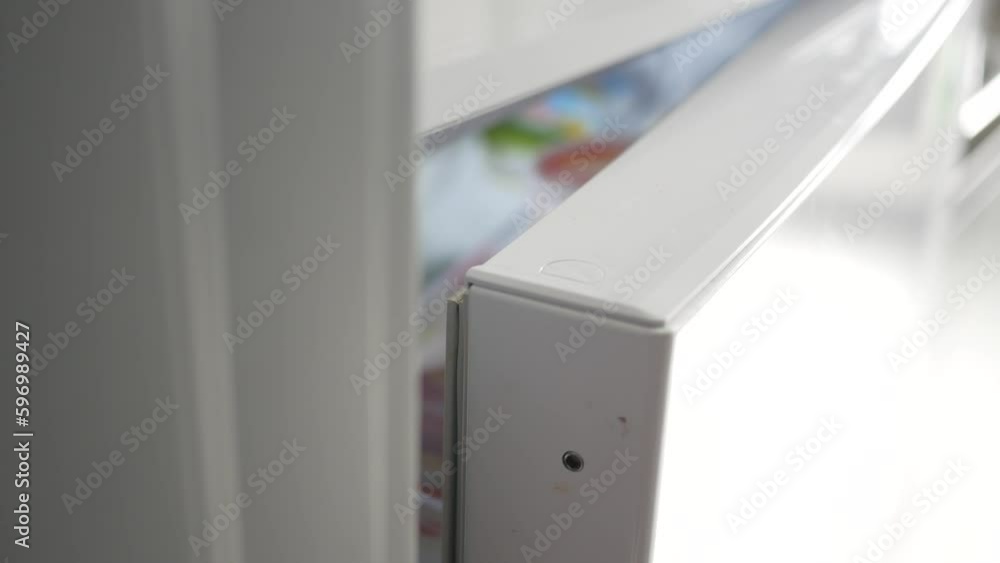 half open fridge with food and vegetables , half open fridge with food and vegetables ,