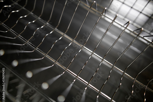 empty dish dryer close-up. dryer for dishes,close-up empty plate dryer in the kitchen. Open tray of dishwasher. Close up view of household appliances in kitchen. Stainless steel cutlery and dish drain