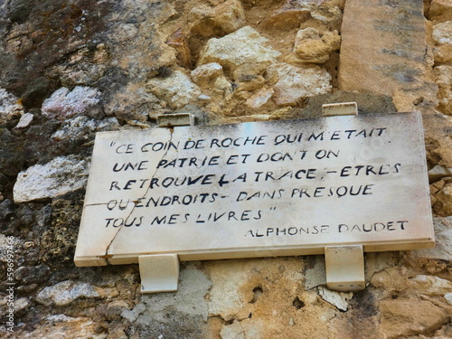 Plaque fixed to the wall of the Daudet mill in Fontvieille in the Alpilles in Provence in France where is inscribed a quote from the famous writer Alphonse Daudet photo