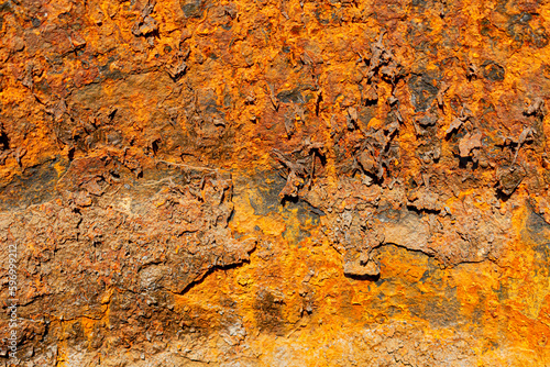 Rust of metals.Corrosive Rust on old iron with a hole. Rusted orange painted metal wall. Rusty metal background with streaks of rust. Old shabby paint.metal rust texture background.