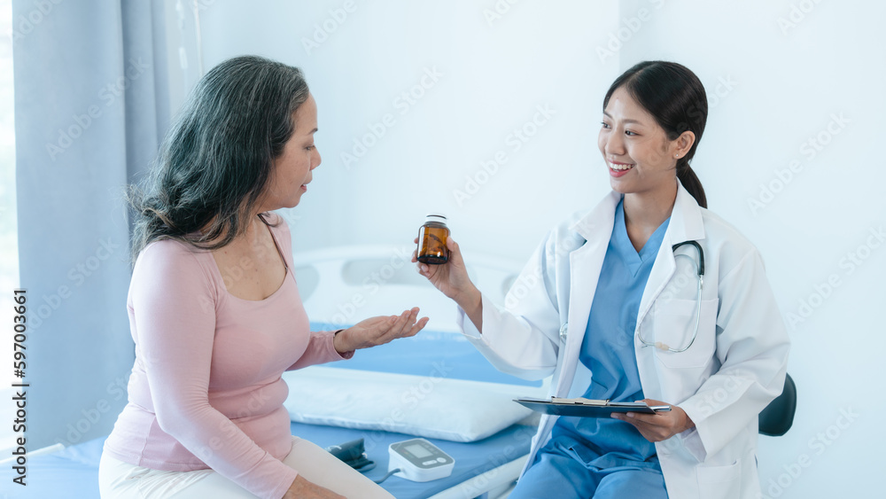 Asian Chinese female physiotherapist caregiver helping elderly woman exercise for recovery, prevention of osteoarthritis and osteoporosis. Asian Chinese female physiotherapist caregiver helping elderly woman exercise for recovery, prevention of osteoarthritis and osteoporosis.