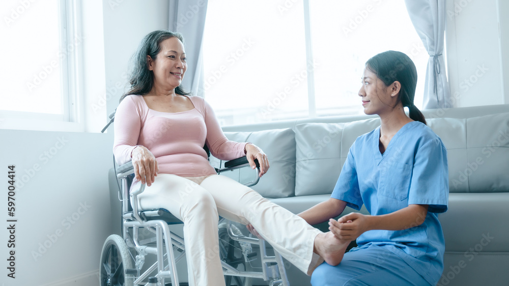Fototapeta premium Asian Chinese female physiotherapist caregiver helping elderly woman exercise for recovery, prevention of osteoarthritis and osteoporosis.