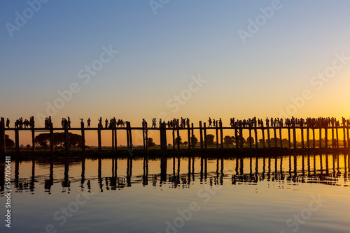 Amarapura  Myanmar - November 22  2016  Unidentified people walk on U Bein bridge at sunset in Myanmar. U Bein bridge is the longest teak bridge in the world.