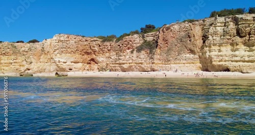 A 4K boat shot of Portugal's Algarve  Beaches and sandstone cliffs  make a striking scene