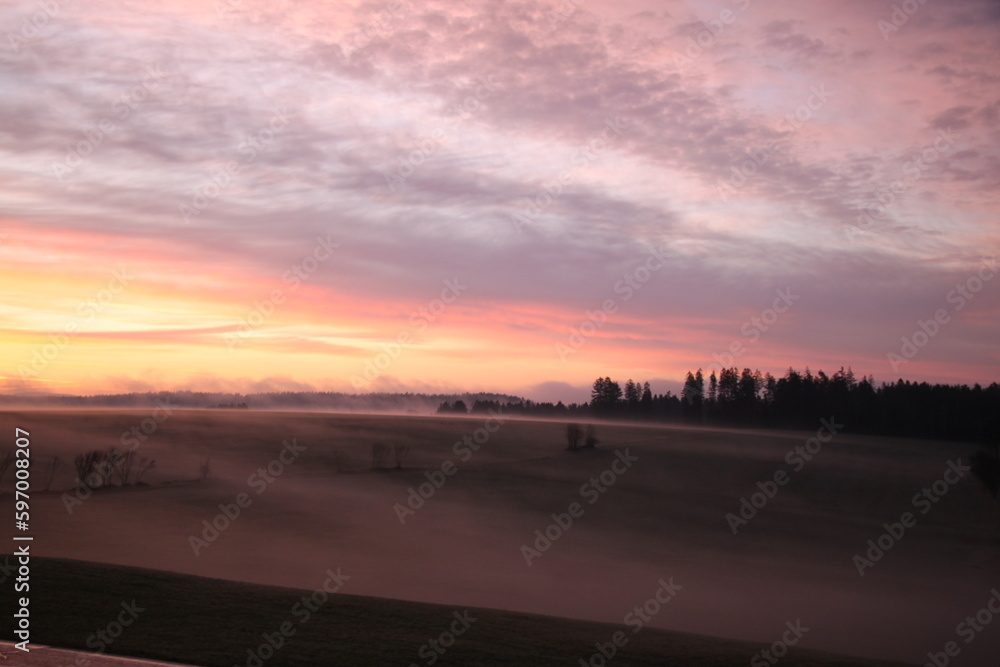 scenic landscape in the morning with fog and sunrise
