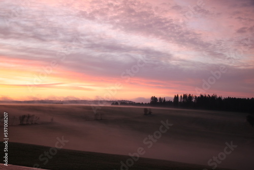 scenic landscape in the morning with fog and sunrise