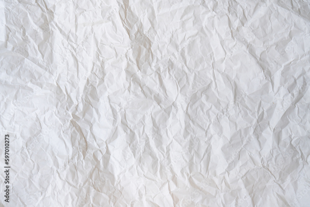 Wrinkled or crumpled white stencil paper or tissue after use in toilet or restroom with large copy space used for background texture in decorative art work Wrinkled or crumpled white stencil paper or tissue after use in toilet or restroom with large copy space used for background texture in decorative art work