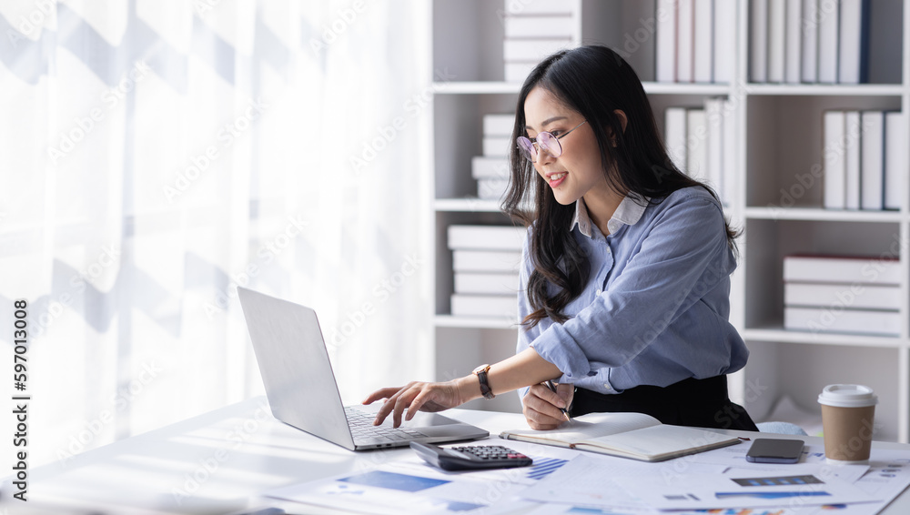 Asian Business woman using calculator and laptop for doing math finance on an office desk, tax, report, accounting, statistics, and analytical research concept
Asian Business woman using calculator and laptop for doing math finance on an office desk, tax, report, accounting, statistics, and analytical research concept
