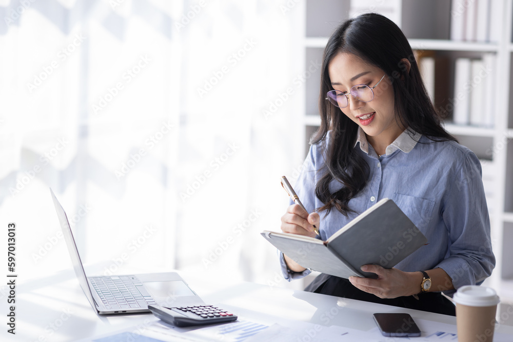 Asian Business woman using calculator and laptop for doing math finance on an office desk, tax, report, accounting, statistics, and analytical research concept
Asian Business woman using calculator and laptop for doing math finance on an office desk, tax, report, accounting, statistics, and analytical research concept