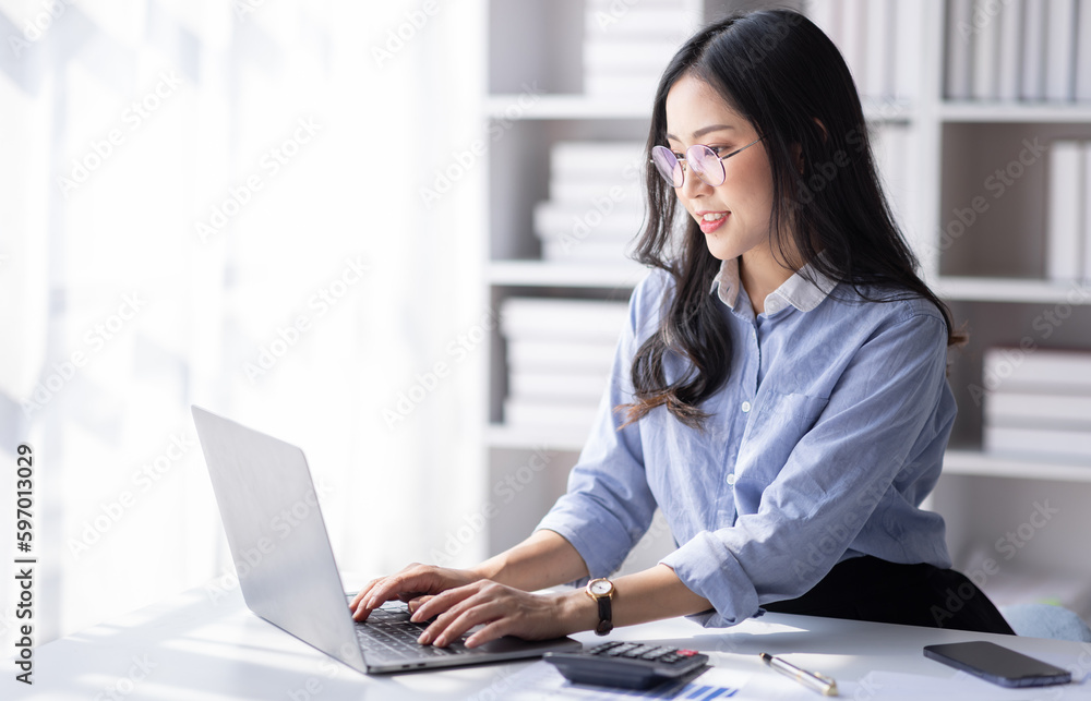 Asian Business woman using calculator and laptop for doing math finance on an office desk, tax, report, accounting, statistics, and analytical research concept
Asian Business woman using calculator and laptop for doing math finance on an office desk, tax, report, accounting, statistics, and analytical research concept