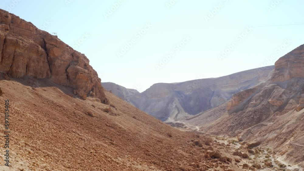 From Madaba to the Dead Sea in Jordan. Landscape of desert mountains with a beautiful cloudless sky. From Madaba to the Dead Sea in Jordan. Landscape of desert mountains with a beautiful cloudless sky.