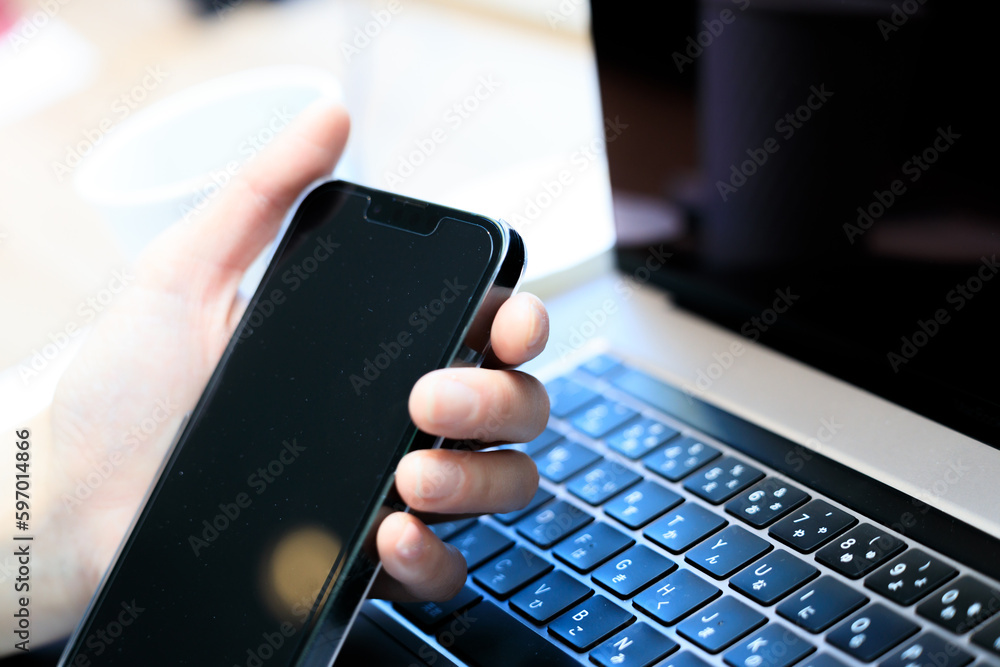 ノートパソコンとスマートフォンを使用している女性 ビジネス ノートパソコンとスマートフォンを使用している女性 ビジネス