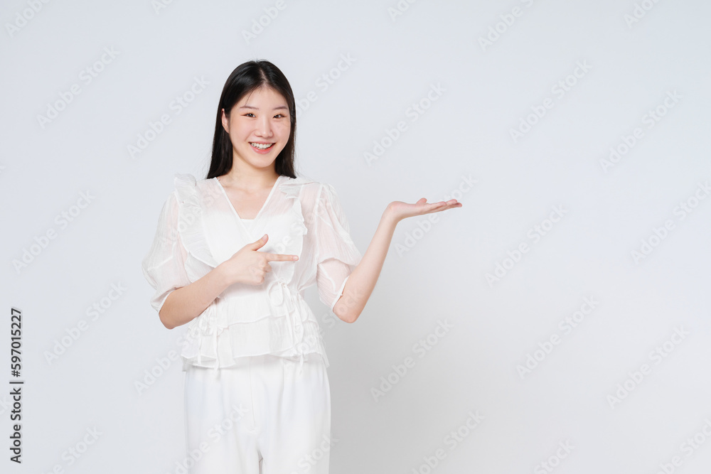 Happy young woman presenting or showing open hand palm with copy space for product isolated on white background. Happy young woman presenting or showing open hand palm with copy space for product isolated on white background.
