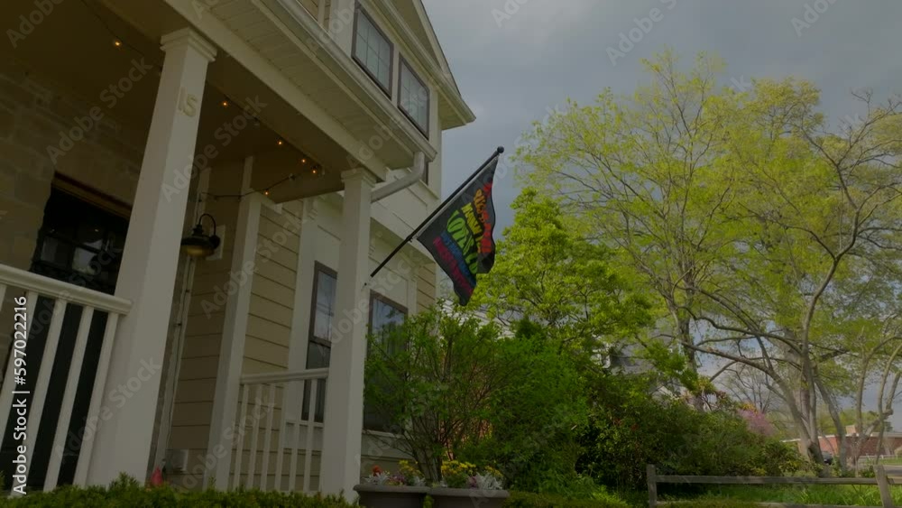 custom made wallpaper toronto digitalPush towards and under rainbow flag on front of nice house in the suburbs.
