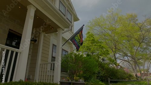 Wallpaper Mural Push towards and under rainbow flag on front of nice house in the suburbs. Torontodigital.ca