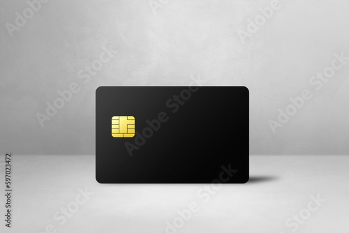 Black credit card on a white concrete background