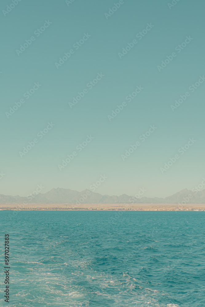 A Blue Sea with a Horizontal Strip of Land. Minimalistic Seascape