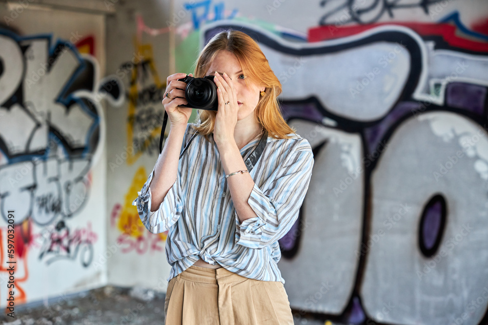 Red hair female in a building with a camera