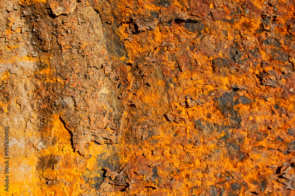 Rust of metals.Corrosive Rust on old iron with a hole. Rusted orange painted metal wall. Rusty metal background with streaks of rust. Old shabby paint.metal rust texture background