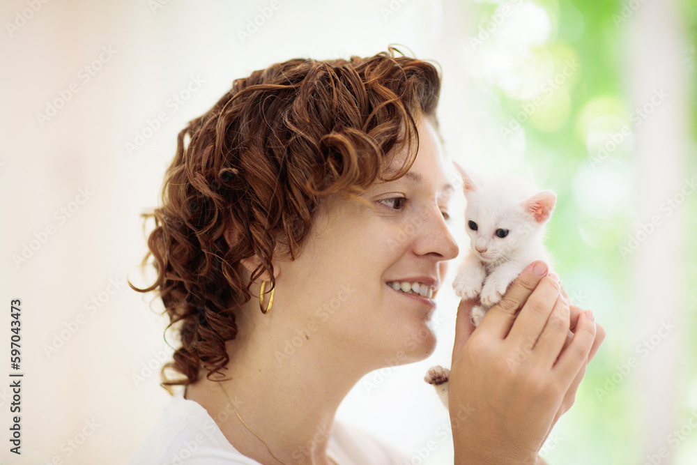 Woman playing with cat. Kitten and owner. Woman playing with cat. Kitten and owner.
