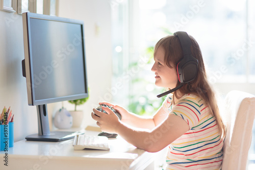 Child doing homework on computer. Online class.