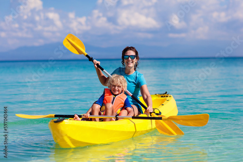 Fototapeta Kids kayaking in ocean. Family in kayak in tropical sea