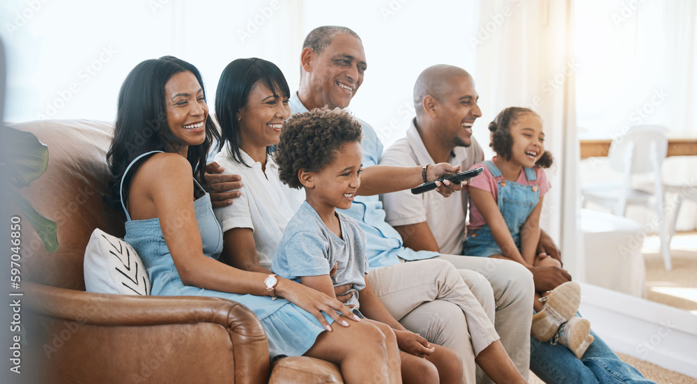 Fototapeta premium Happy, big family and watching tv on the sofa together, enjoying a film or comedy show at home. Smile, living room and parents, grandparents and children laughing at the television for happiness