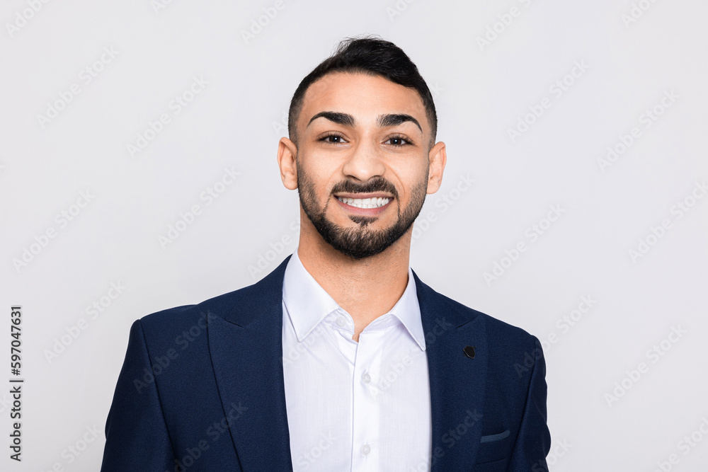 Portrait of happy delighted turkish man in studio isolated over grey background looking at camera smiling with white teeth buisneesman young successful guy. Portrait of happy delighted turkish man in studio isolated over grey background looking at camera smiling with white teeth buisneesman young successful guy.