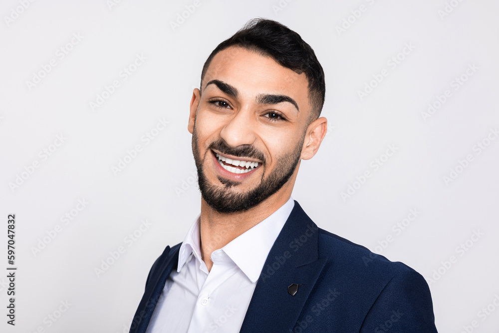 Sussessful turkish guy with white teeth beautiful smile standing over white background in studio laughing having great fun. Sussessful turkish guy with white teeth beautiful smile standing over white background in studio laughing having great fun.