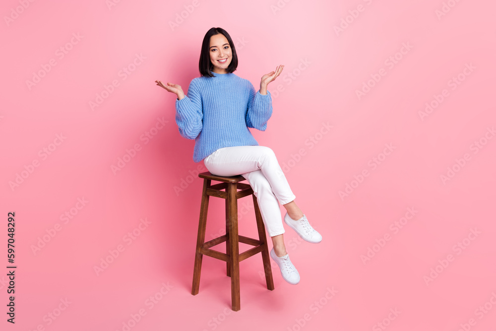 Full length portrait of satisfied cheerful lady sitting chair communicate good mood isolated on pink color background Full length portrait of satisfied cheerful lady sitting chair communicate good mood isolated on pink color background