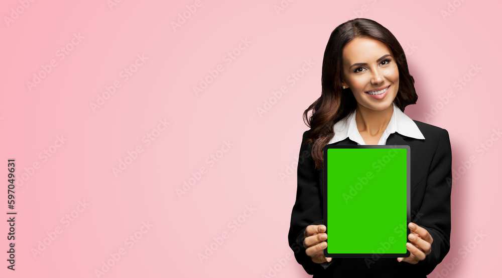 Portrait of happy smiling brunette businesswoman showing tablet pc, touchpad, with green chroma key screen, on rose pink background. Cheerful beautiful business woman at office. Portrait of happy smiling brunette businesswoman showing tablet pc, touchpad, with green chroma key screen, on rose pink background. Cheerful beautiful business woman at office.