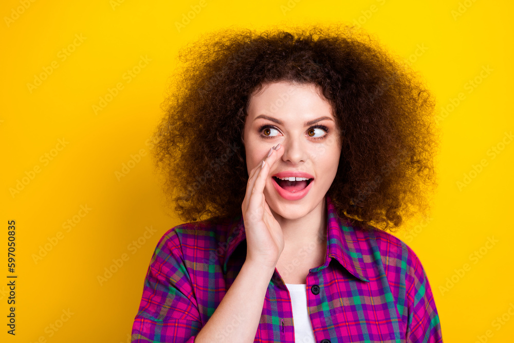 Photo of pretty tricky woman dressed plaid shirt arm lips talking secret empty space isolated yellow color background Photo of pretty tricky woman dressed plaid shirt arm lips talking secret empty space isolated yellow color background