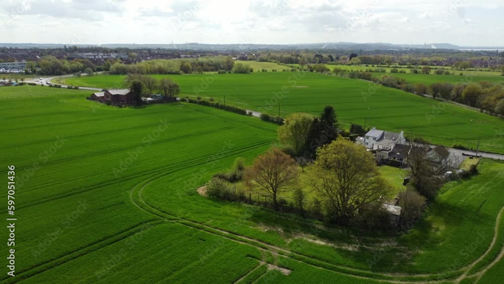 Rural British farmhouse aerial view surrounded by lush green trees and agricultural meadow farmland countryside Rural British farmhouse aerial view surrounded by lush green trees and agricultural meadow farmland countryside