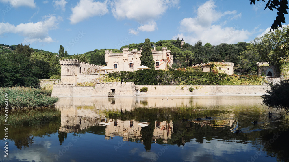 Lake with ducks and castle reflected in the water. Jal pi castle in Arenys de munt, 20th century, located in the Maresme region. Tourist sites near Barcelona.
