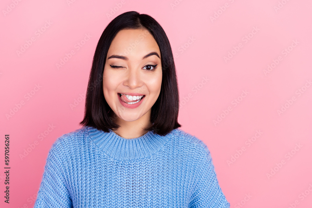Photo of pretty cheerful lady eye wink blink tongue lick teeth beaming smile isolated on pink color background Photo of pretty cheerful lady eye wink blink tongue lick teeth beaming smile isolated on pink color background