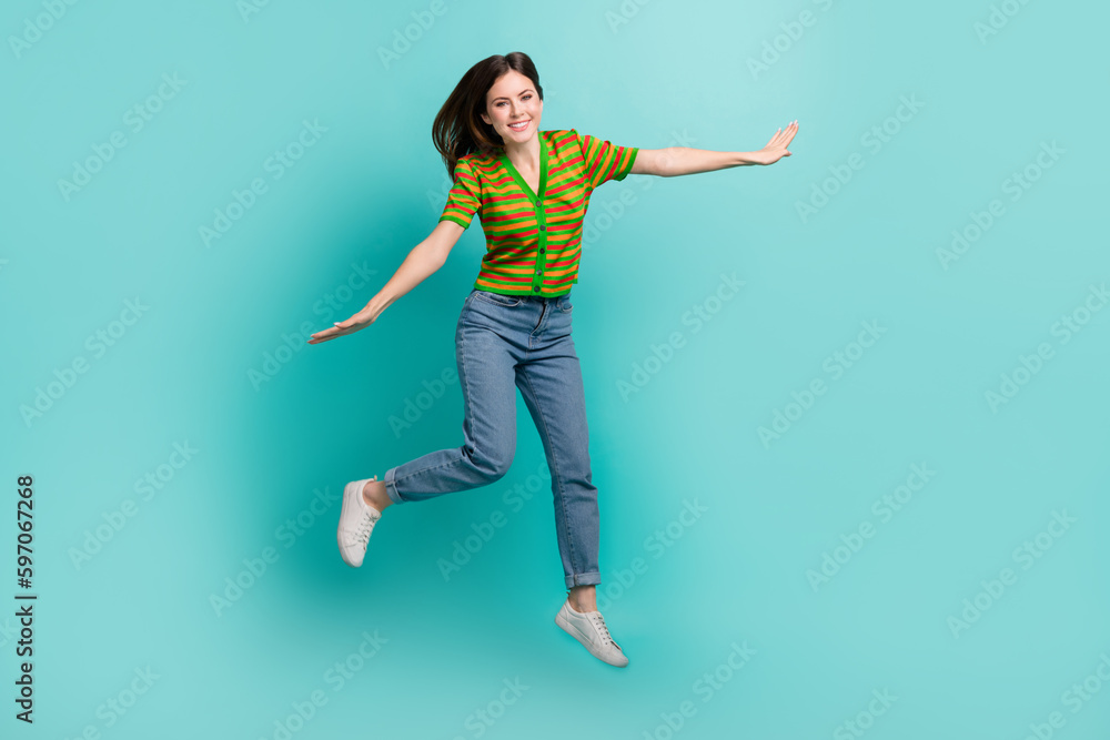 Full length photo of overjoyed cheerful pretty lady have fun dream flight abroad empty space isolated on cyan color background