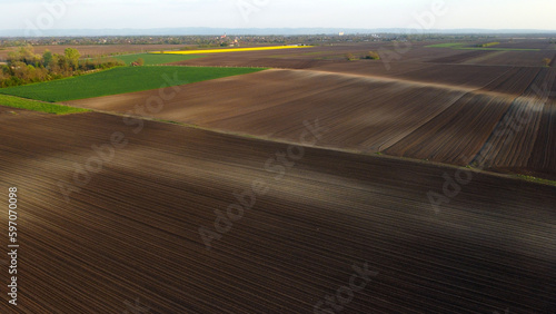 arable land and agricultural fields in the spring seen from above