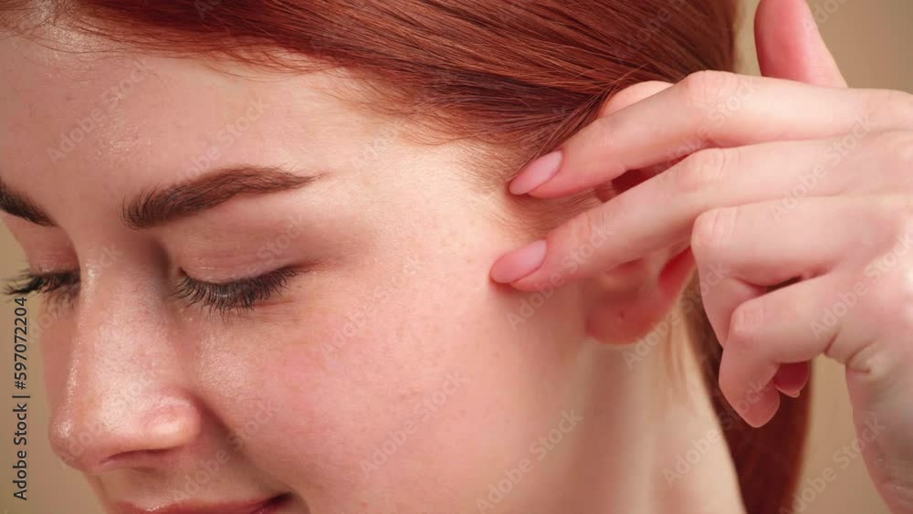 Young beautiful girl with red hair and green eyes on beige background, closeup. Camera tracking movements Young beautiful girl with red hair and green eyes on beige background, closeup. Camera tracking movements