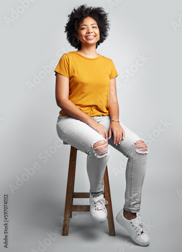 Принти на полотні Portrait, smile and woman sitting on stool in studio isolated on a white background