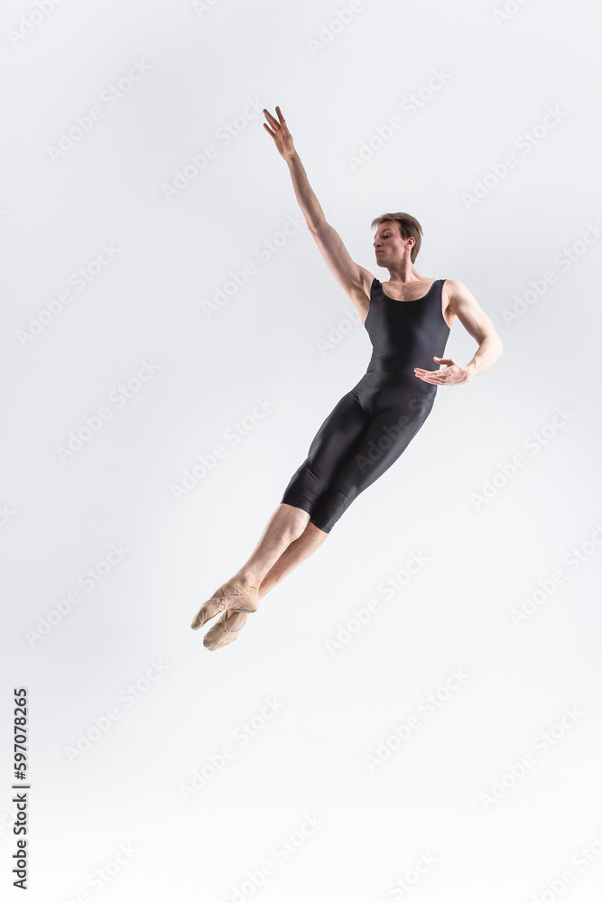 Caucasian Ballet Dancer Young Caucasian Athletic Man in Black Suit Posing Flying Dancing in Studio On White