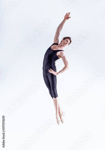 Ballet Dance Concepts. Contemporary Art Ballet With Young Handsome Caucasian Dancing Athletic Man In Studio On White Background.